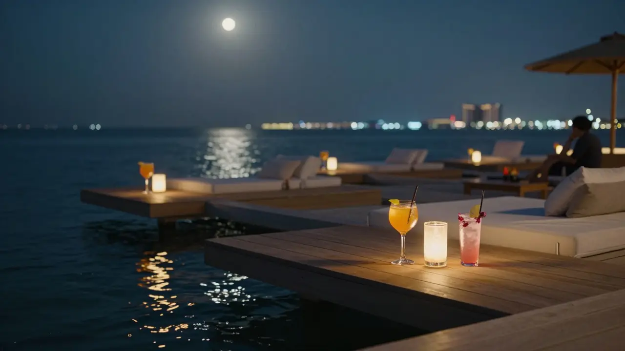 Floating lounge on calm water at night with glowing cocktails and city lights reflecting on the surface.
