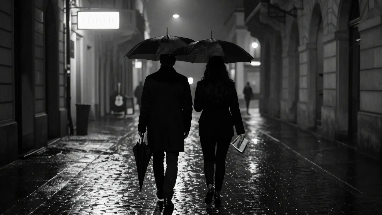 Two anonymous figures walking through the empty, rain-slicked Brera district at night, silhouetted beneath a gallery’s glowing sign.