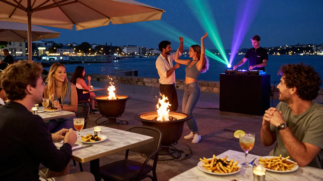 Vibrant open-air party at Café de Paris with fire pits, dancing, and harbor lights in the background.